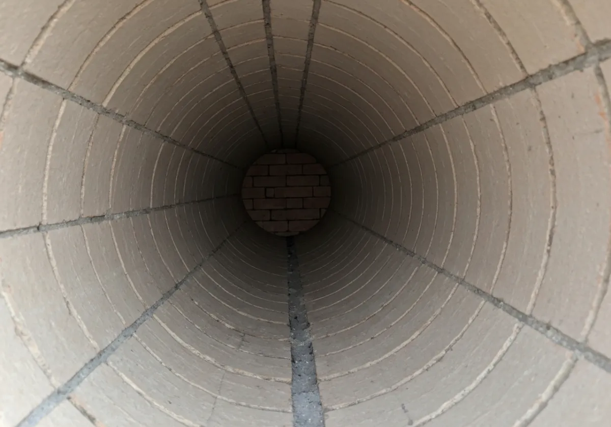 After — creosote removal: Heavy glazed creosote buildup removed back to clean masonry to cut fire risk.